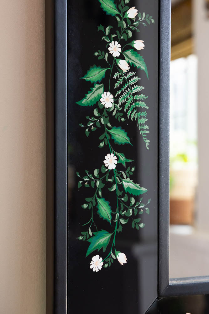 Miroir encadré en bois noir et floral