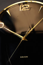 Horloge murale noire et dorée