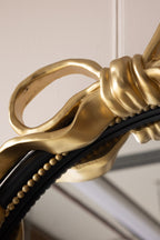 Miroir mural rond avec nœud noir et or