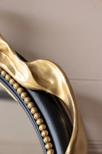 Miroir mural rond avec nœud noir et or